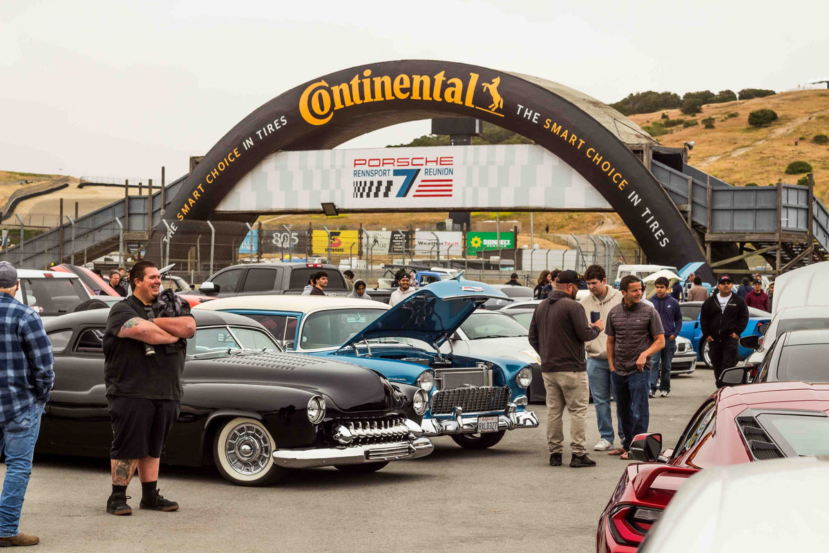 Cars and Coffee attendees viewing automobiles at Laguna Seca
