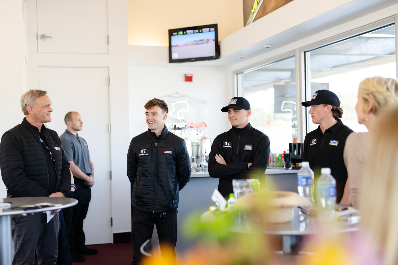 Champions Club guests meeting INDYCAR drivers inside a hospitality suite