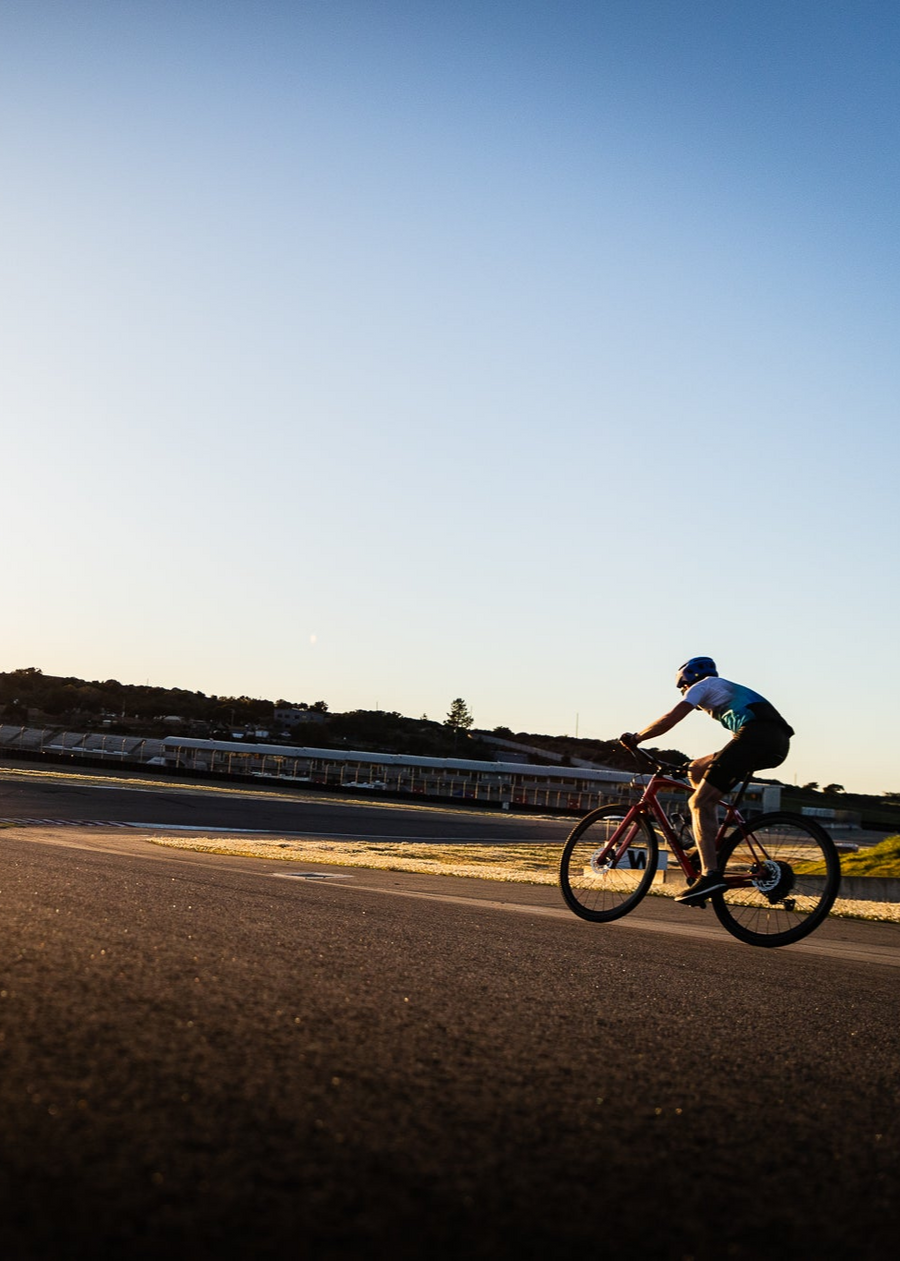 Cyclist riding at WeatherTech Raceway Laguna Seca during Twilight Cycling